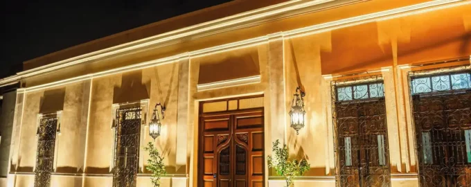 Illuminated entrance of Adoro Hotel Boutique at night