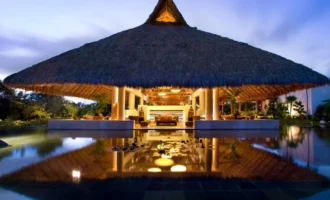 Illuminated thatched-roof pavilion at Blue Diamond Wellness Resort in Riviera Maya