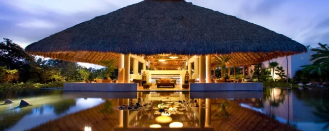 Illuminated thatched-roof pavilion at Blue Diamond Wellness Resort in Riviera Maya